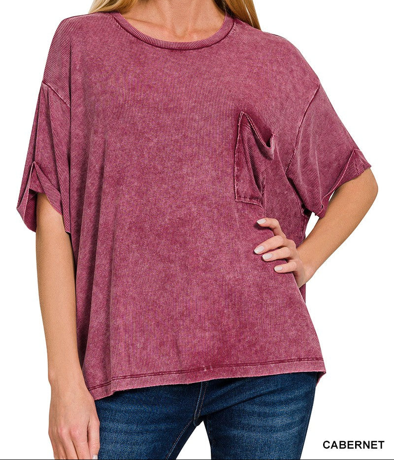 Woman wearing a acid wash cabernet oversized shirt with a pocket on a white background