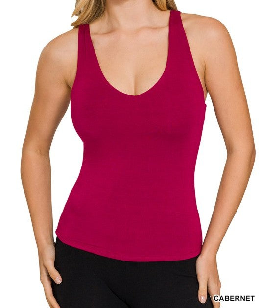 Woman wearing a cabernet  tank top on a white background